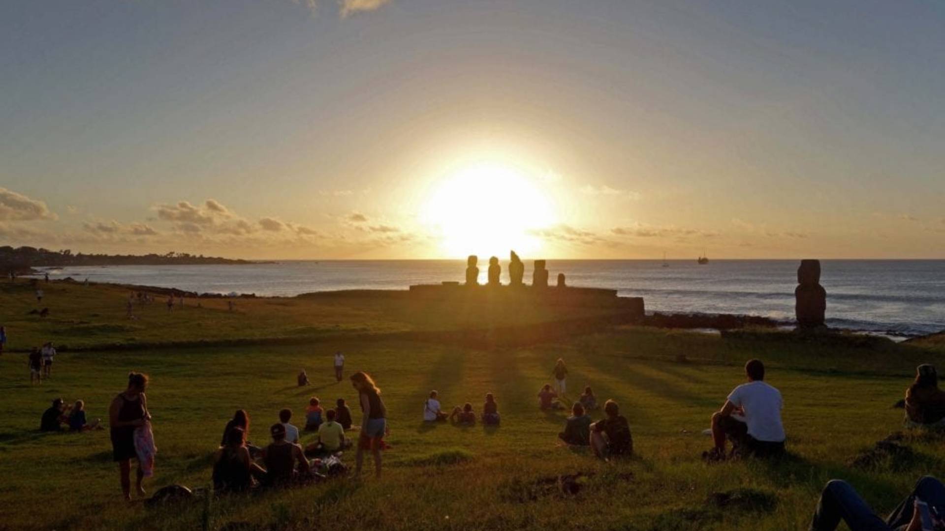 PEOPLE HAVING FUN IN FRONT OF EASTER ISLAND SUNSET