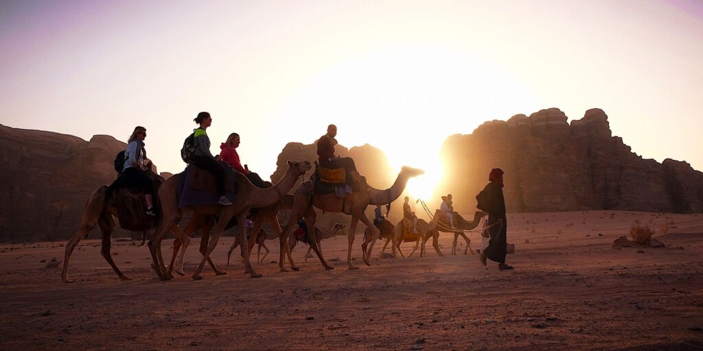 People riding camels in Jordan