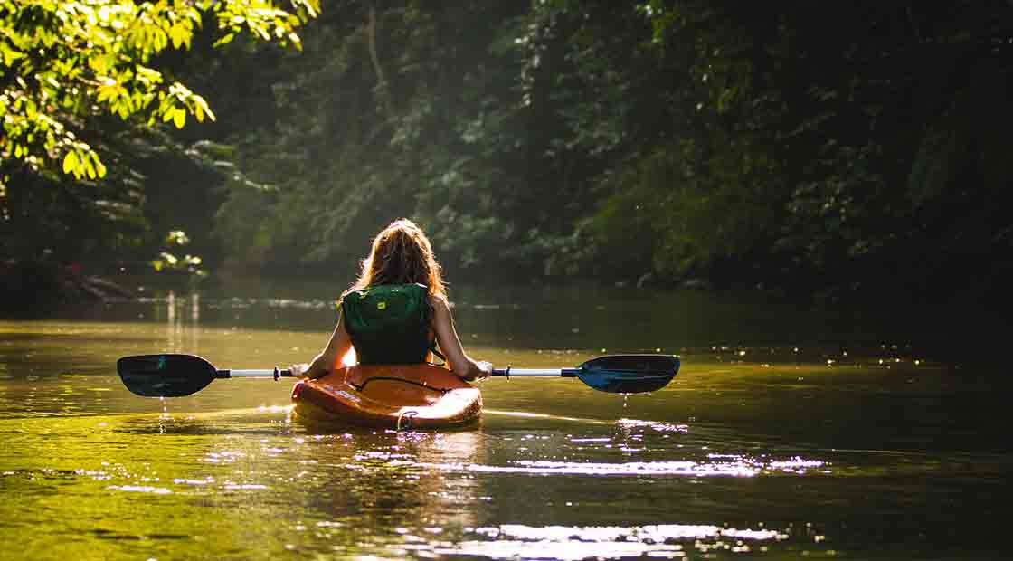 A woman kayaking on a river in Costa Rica