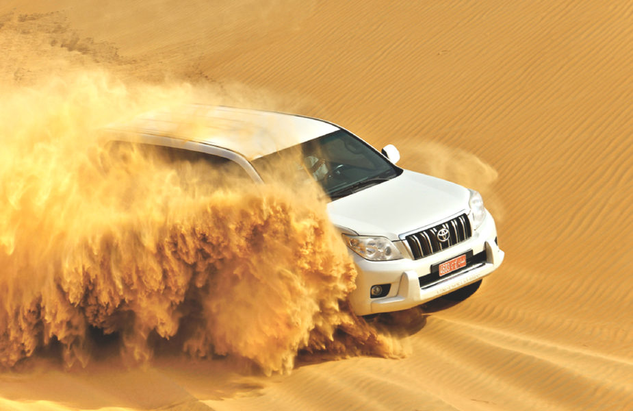 Dune bashing in a white jeep