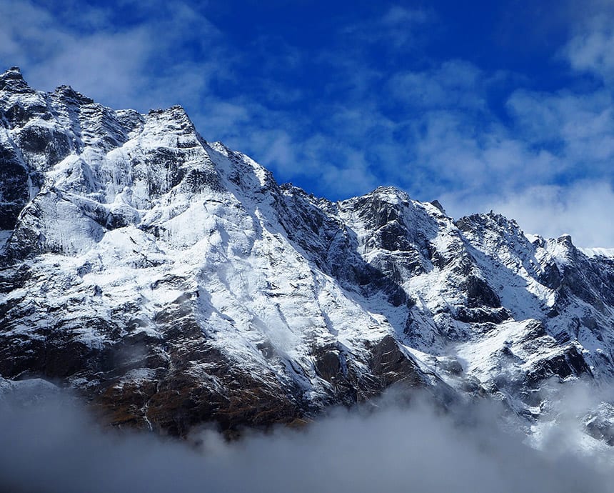 Mount Everest emerging through a layer of cloud
