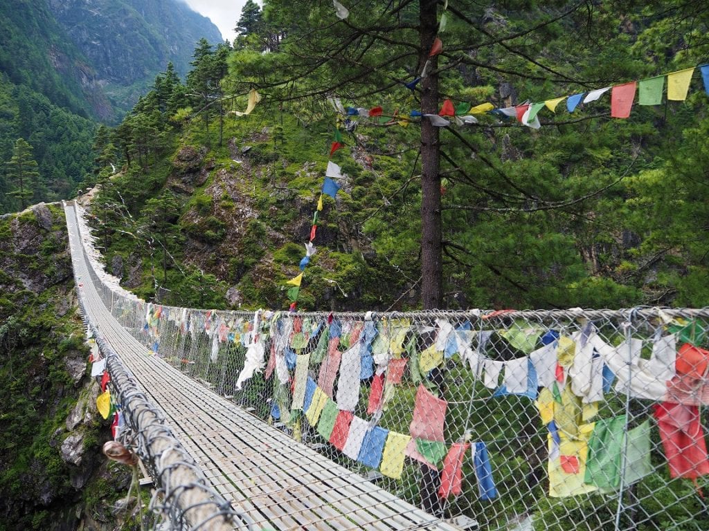 Prayer flags lining a suspension bridge on Mount Everest