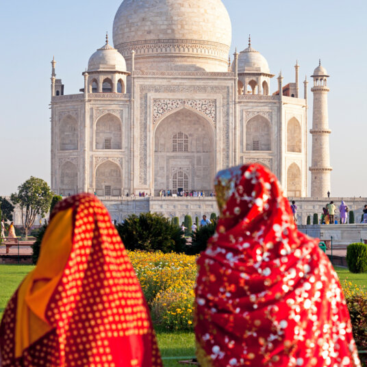 Two ladies facing the Taj Mahal