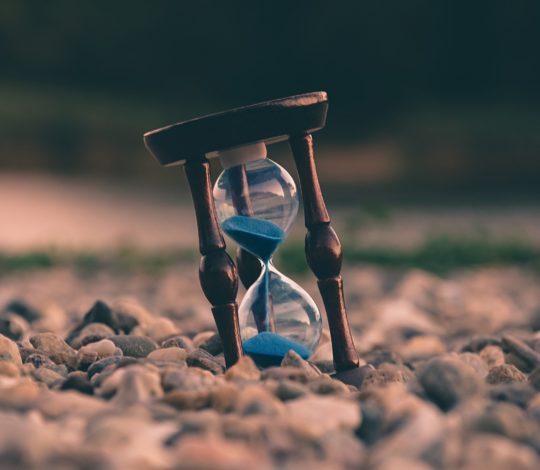 hour glass on pebble beach
