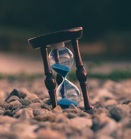 hour glass on pebble beach