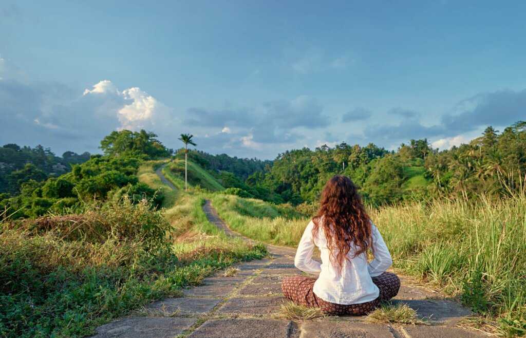 Woman meditating in the hillsides of Ubud, Bali