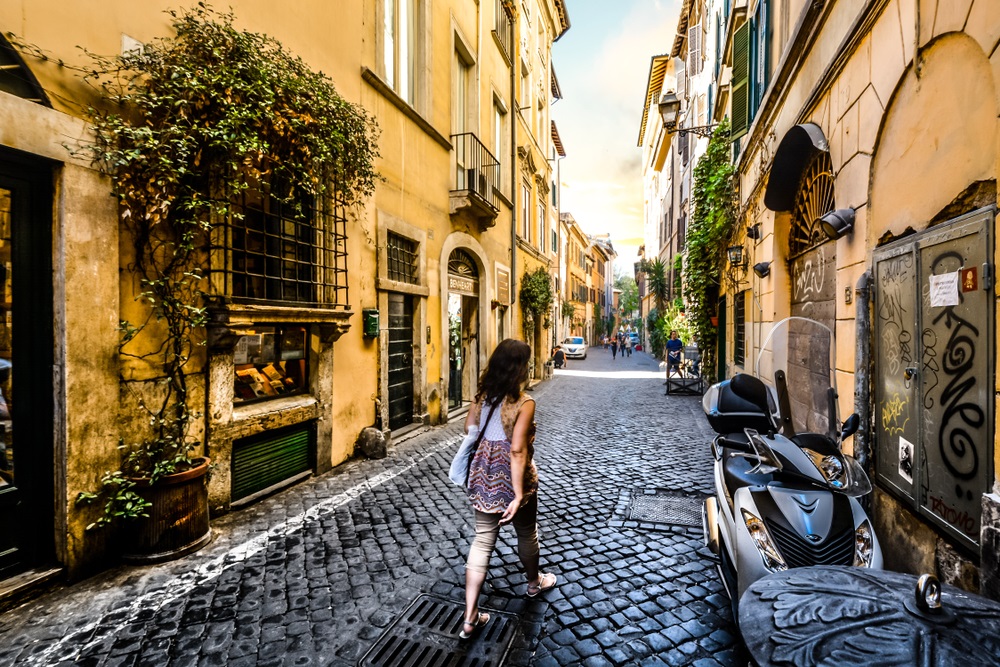 Woman walking down a street in Italy