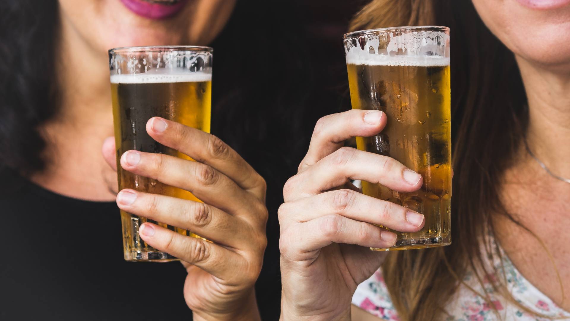 women over 40 holding beer glasses