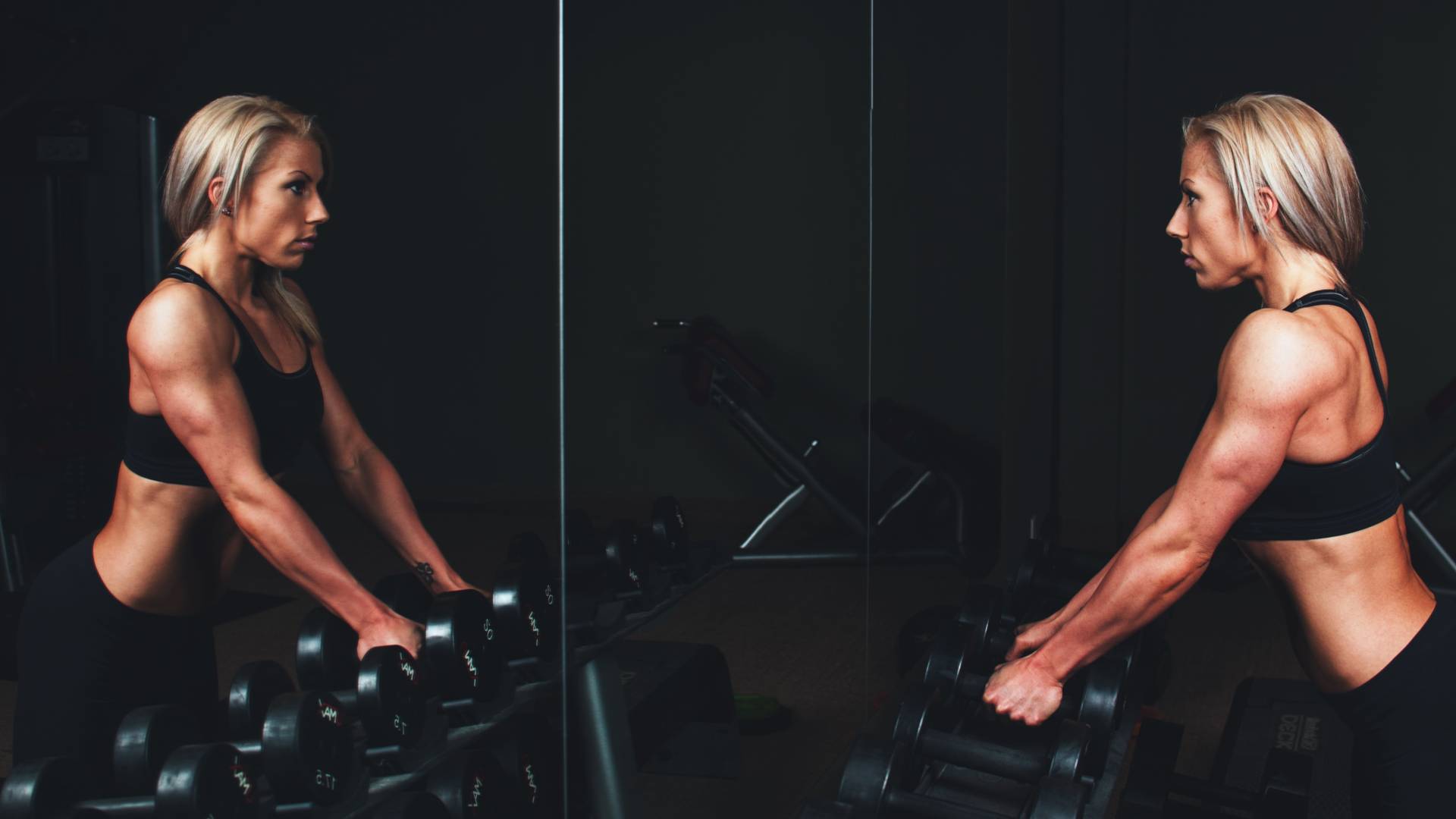 woman over 40 lifting weights in gym