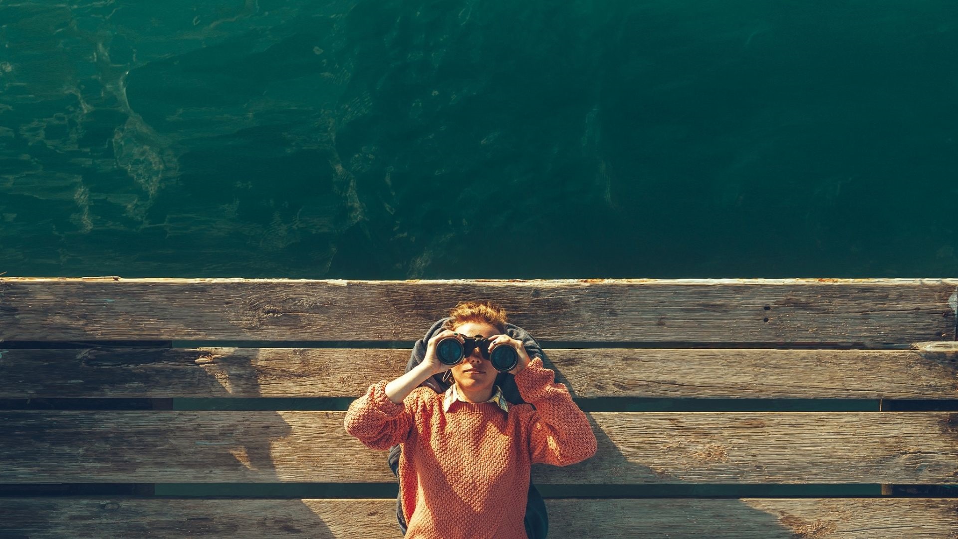 A woman looks through binoculars