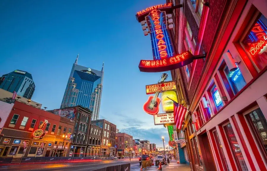 The neon signs of Broadway in Downtown Nashville at twilight
