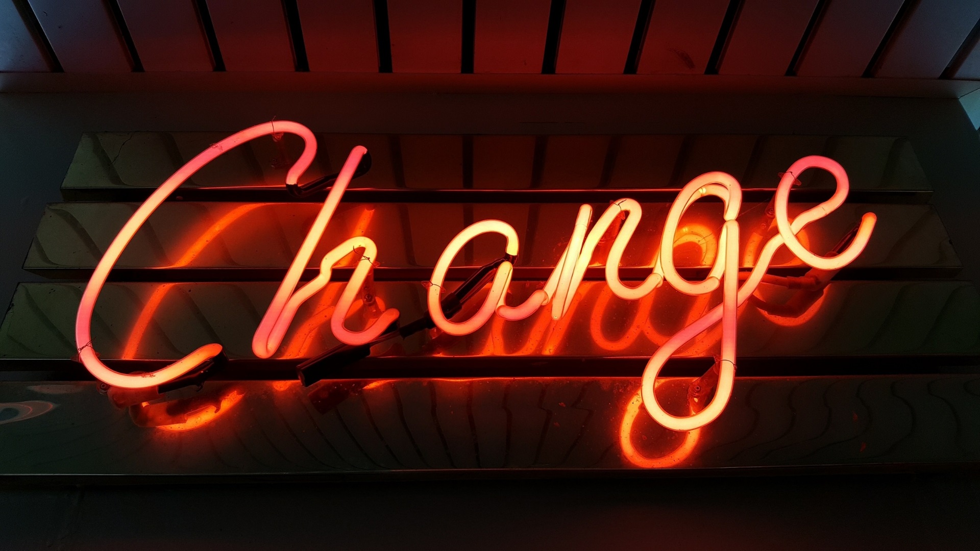 A neon sign that reads "change"