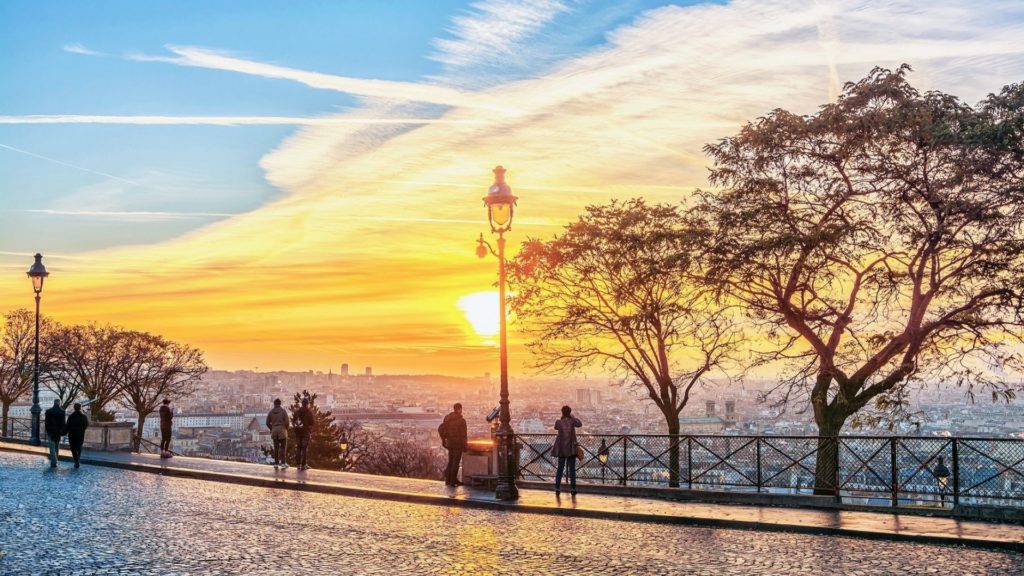 People observing the panoramic view of Paris from Montmartre