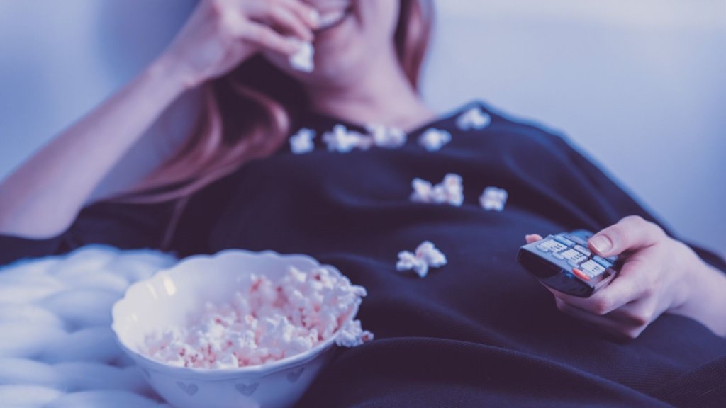 Life in your 30s - a person with a bowl of popcorn and a remote control