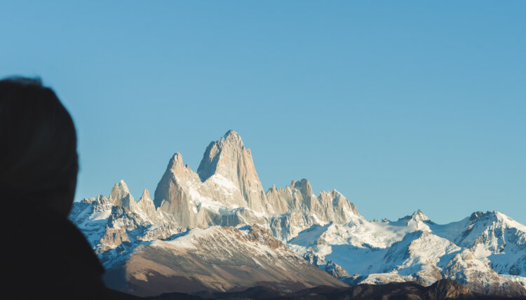 Silhoutte of a person in front of the Andes mountain range in Argentina